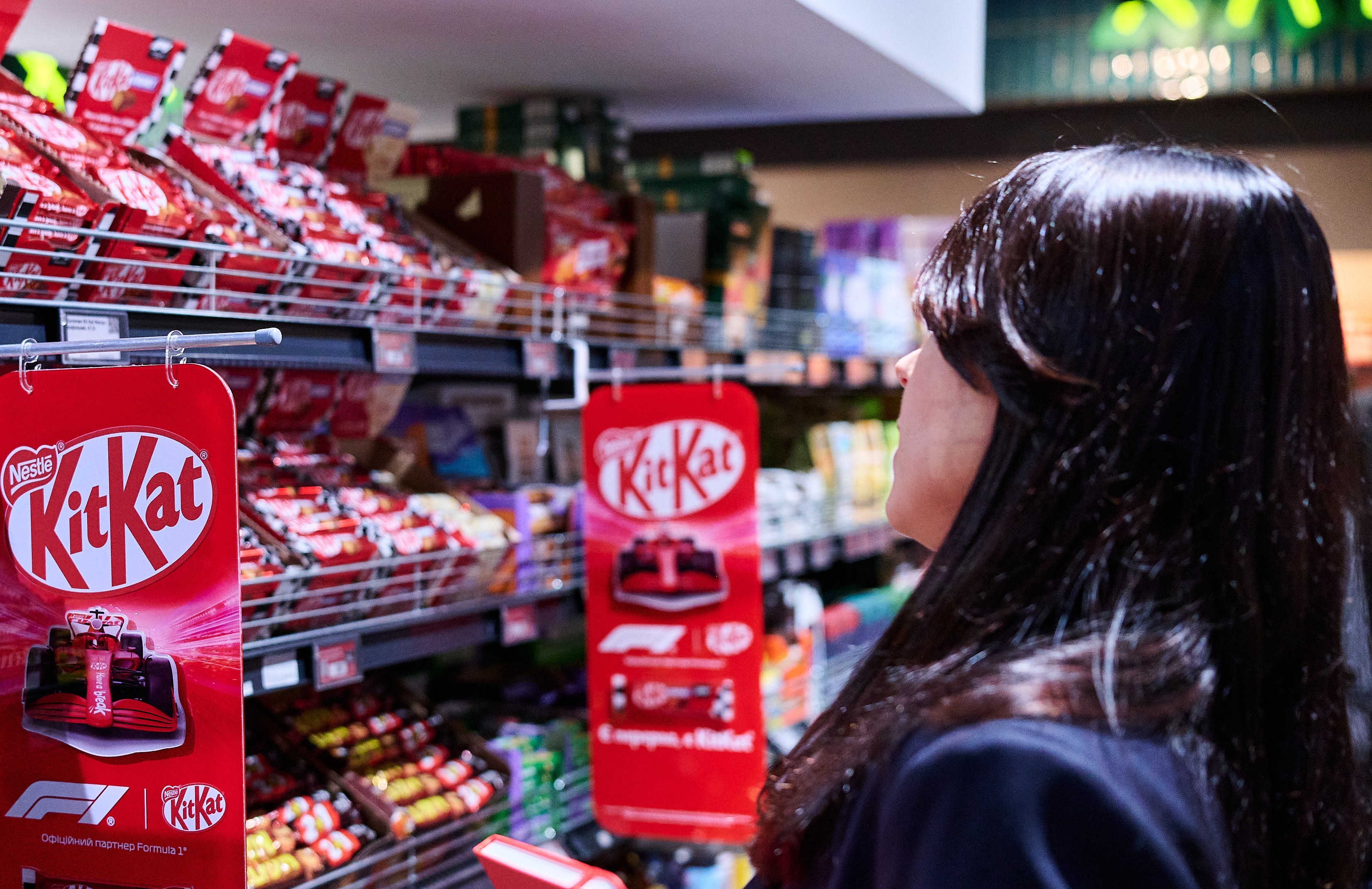Shopper Viewing KitKat Products in Supermarket