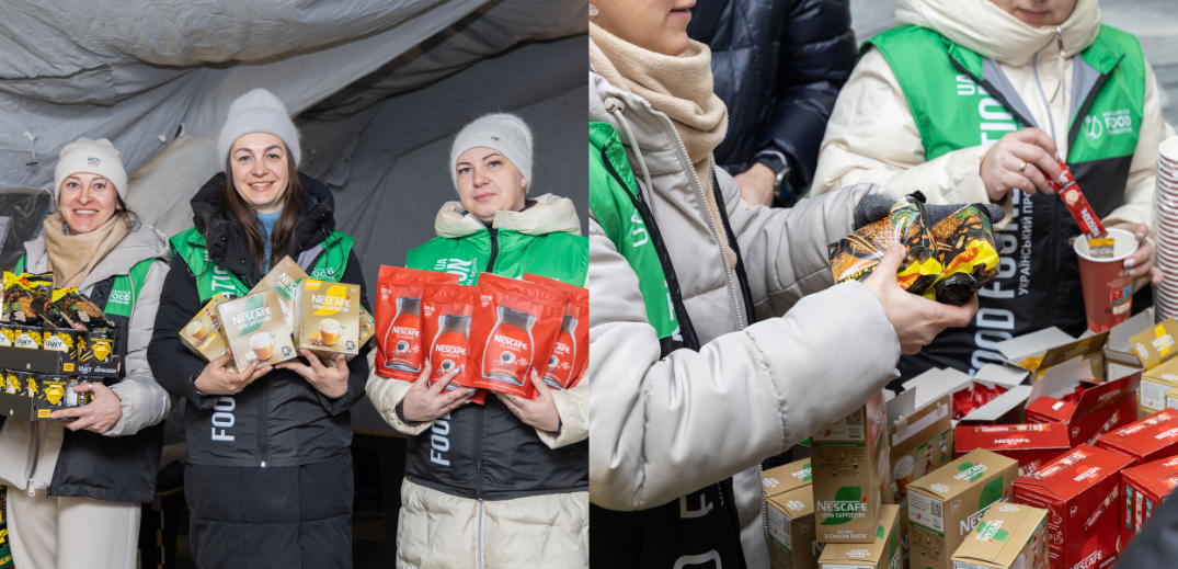 Volunteers in green vests distributing various Nescafe coffee products at a food aid station inside a tent.